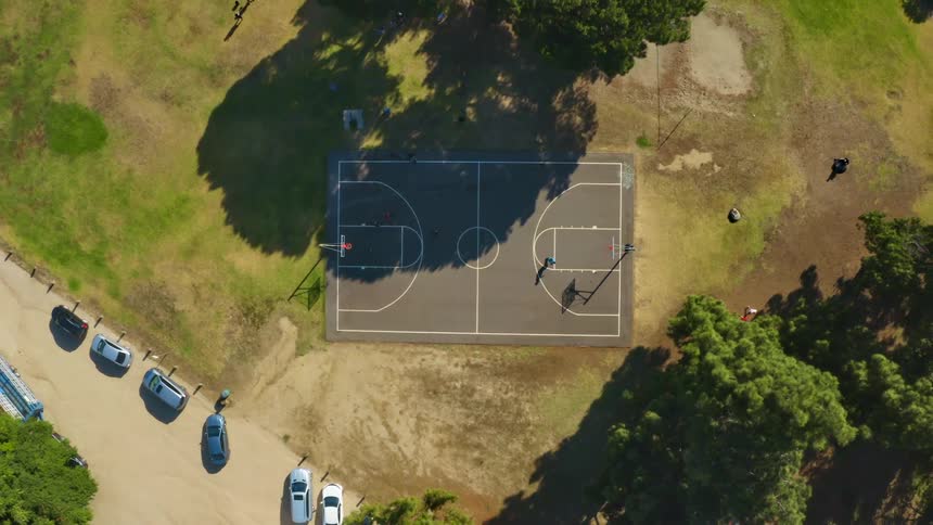People are playing basketball on the court