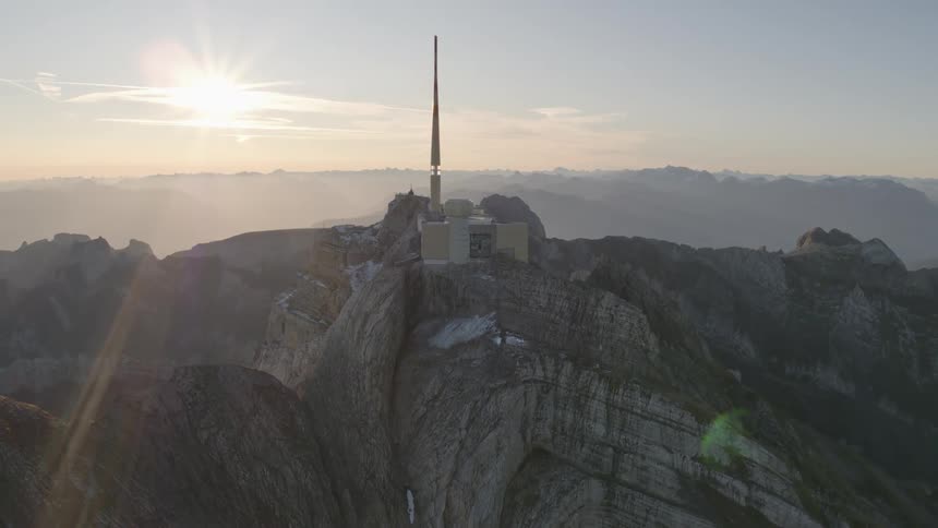 Building with a tall tower sits on top of a mountain