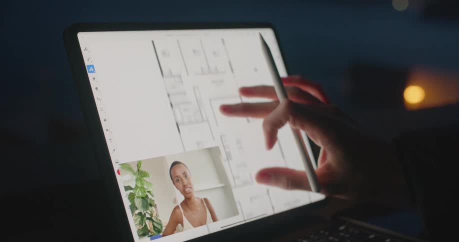 Two people video call and discuss house plans on laptop