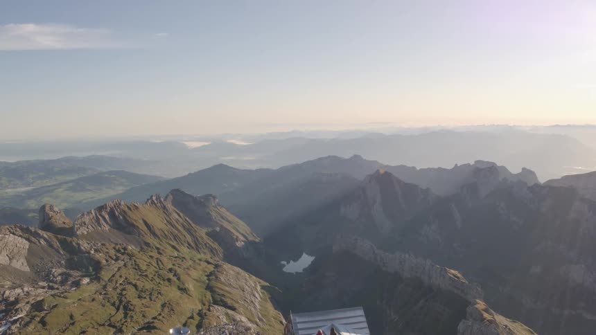 Two tourists reclined on the handrail in the observatory deck on the mountaintop at morning