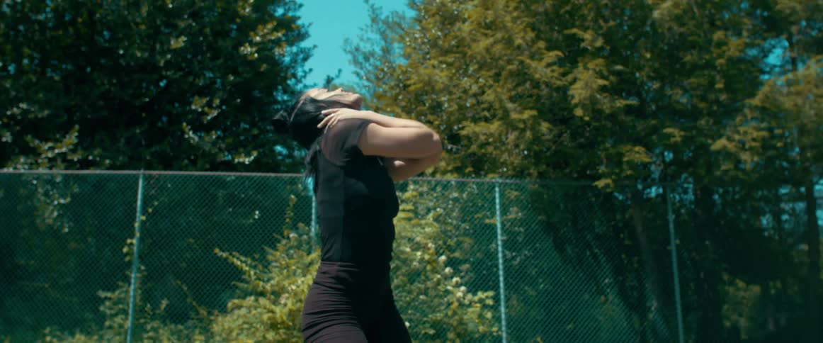 A woman is dancing in the yard