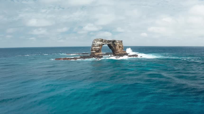 A view of a rock in the middle of the ocean