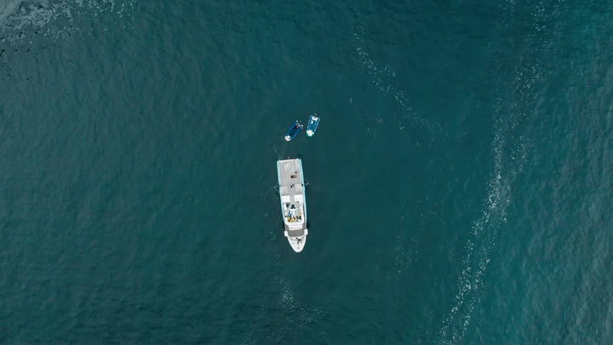 An aerial shot of a boat in the ocean