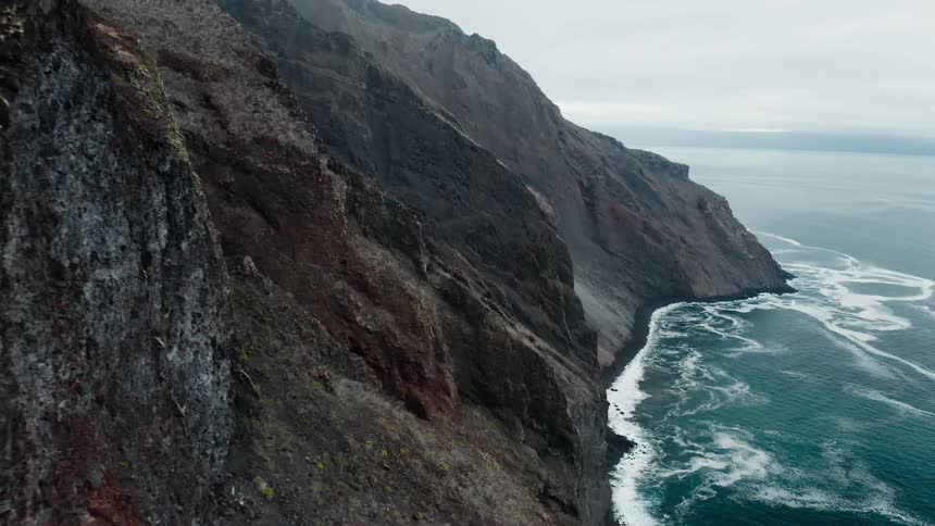 Cinematic shot of mountains beside the coast