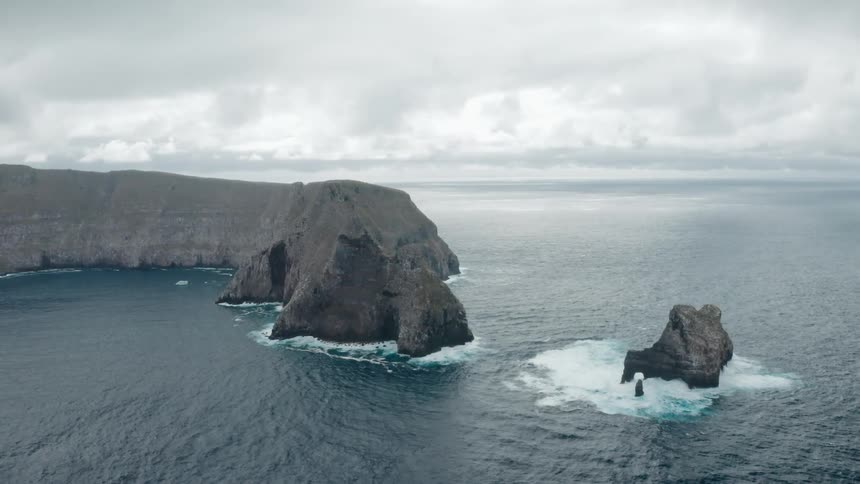 Aerial shot of rocks in an ocean
