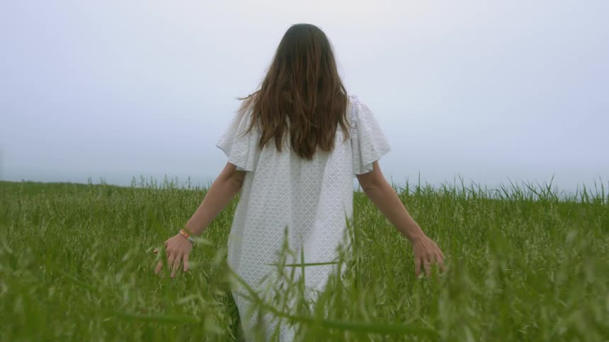 A woman walking out in a field