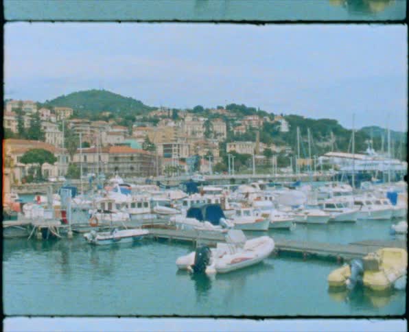 Boats docked on a pier next to a small coastal town