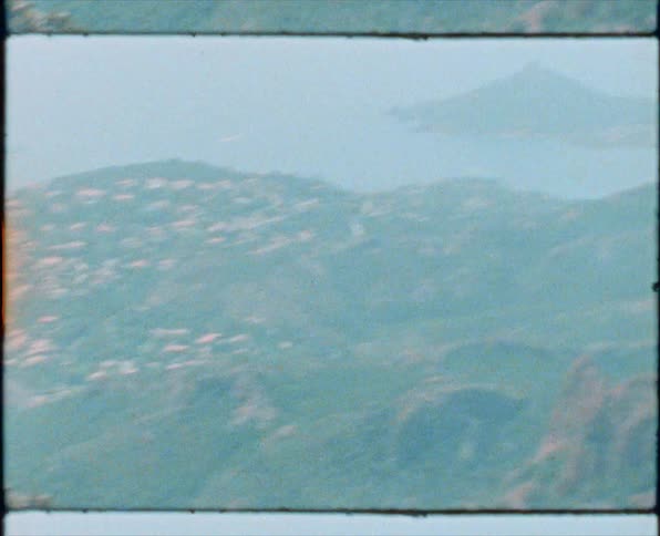 A view of a city and mountains from a hill