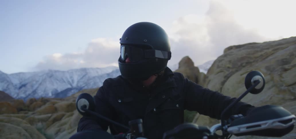 A man sitting on a motorcycle outdoors