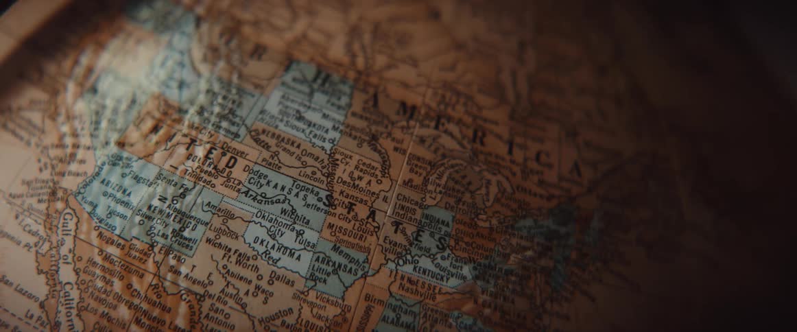 World globe slowly rotates showing labeled geographical locations