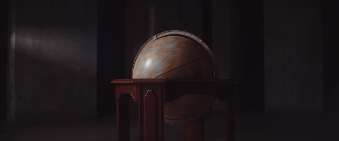 A globe spinning in a room with a wall in the background