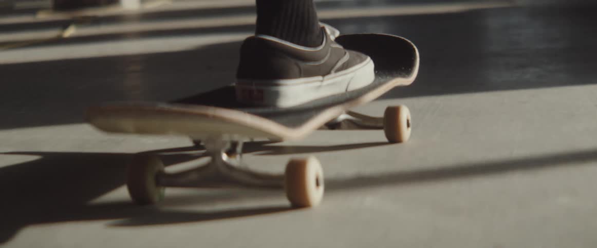 Young person riding a skateboard inside a building