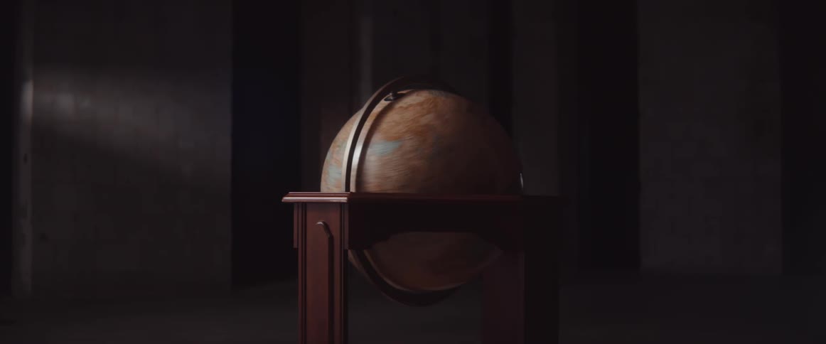 A globe in a room spinning with a wall in the background