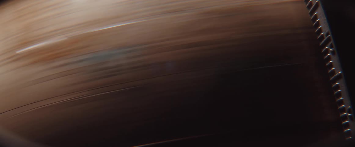 A brown and blue globe with a metal holder is spinning very fast