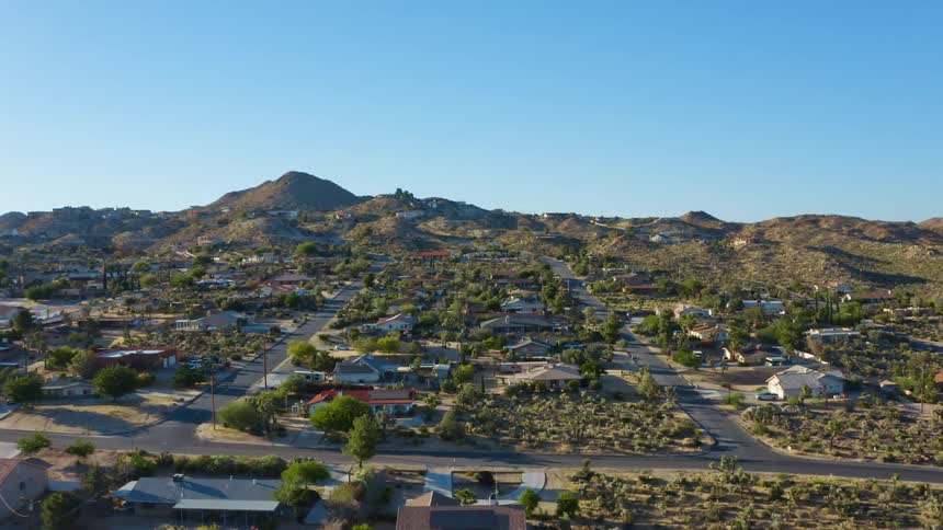 Aerial view of houses in a small town neighborhood near the hills at morning