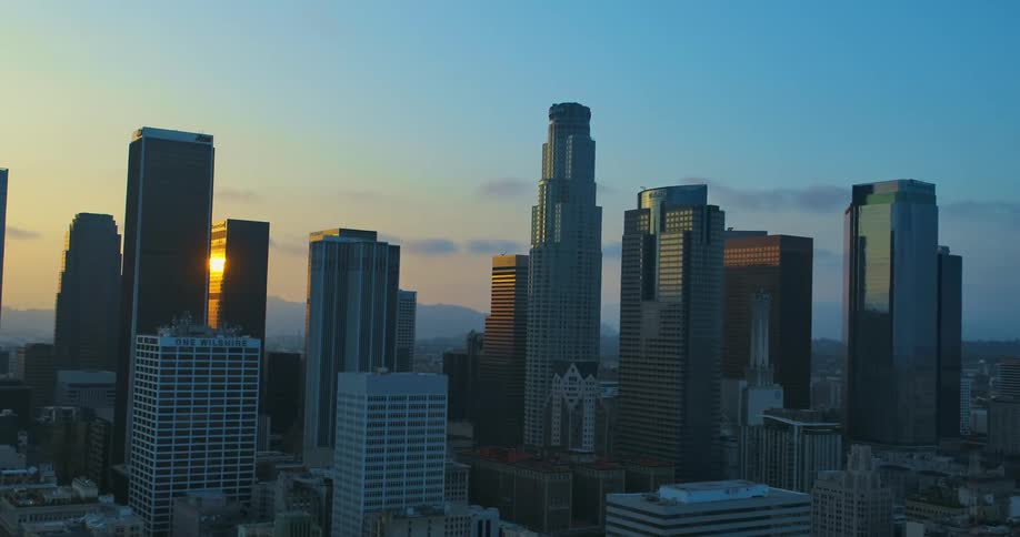 Aerial view of tall skyscrapers on the city skyline at sunset