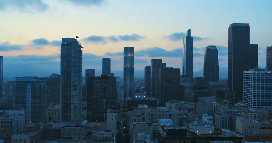 Aerial view of high rise buildings and skyscraper in the city at dusk