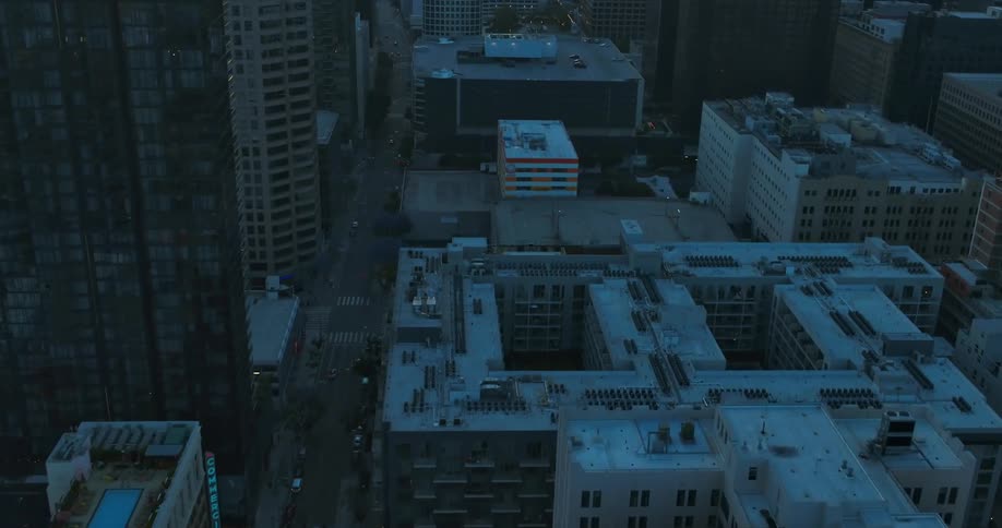 Buildings sit in the city as vehicles travel on the streets