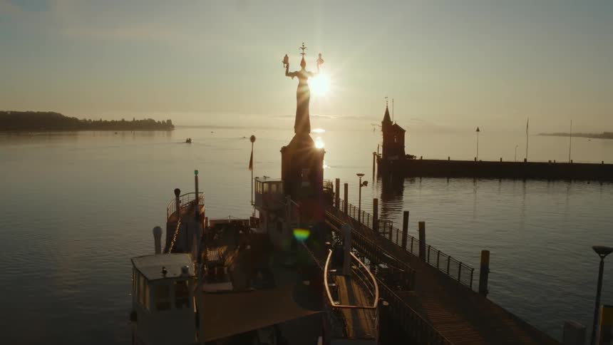 Piers sit in the ocean water as the sun rises