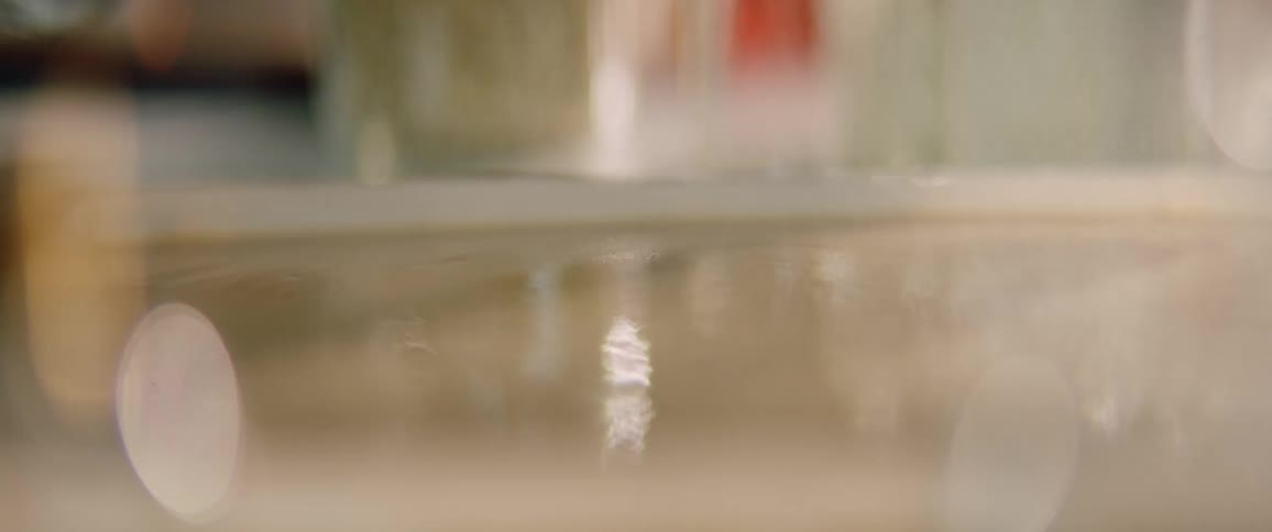 A person is putting powder on a table