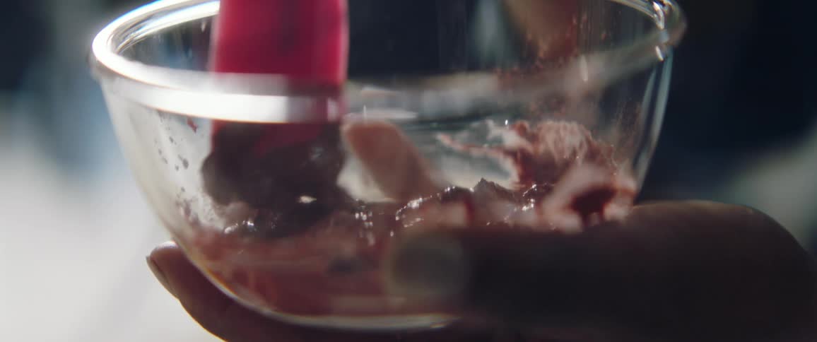 A person stirring food in a bowl