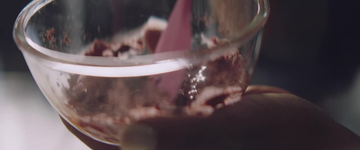 A person stirring chocolate in a bowl
