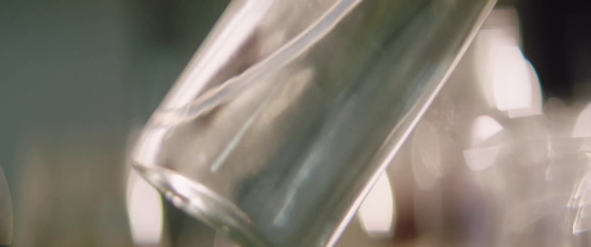 A glass bottle filled with clear liquid