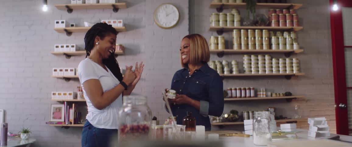 Two women talking in a room to each other