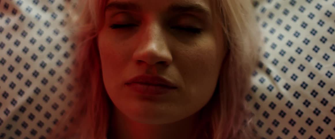 A woman opens her eyes as she wakes up from sleeping