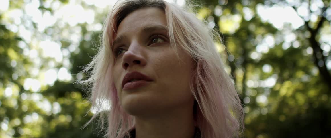 A portrait of a woman standing out in the forest