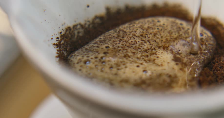 Water pouring into a pour-over coffee brewer