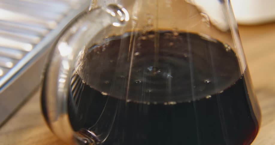 Coffee dripping in a coffee maker on a table