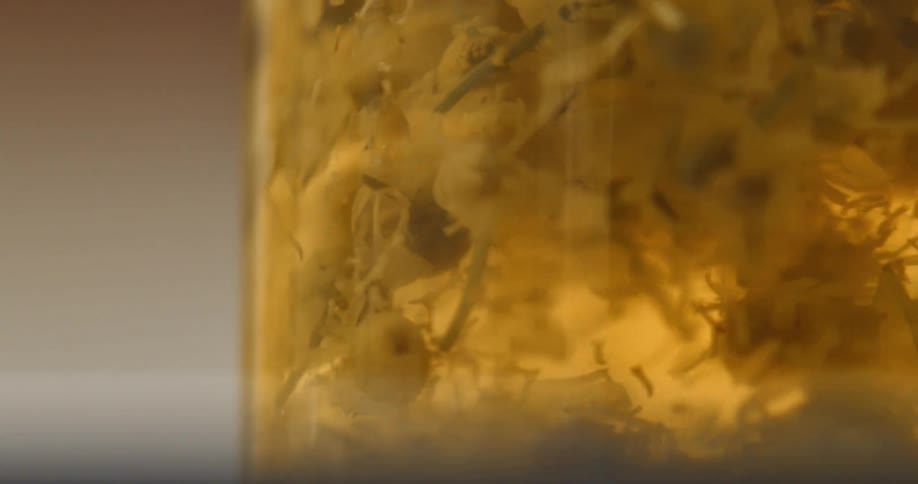 A liquid with debris swirling in a container in a room