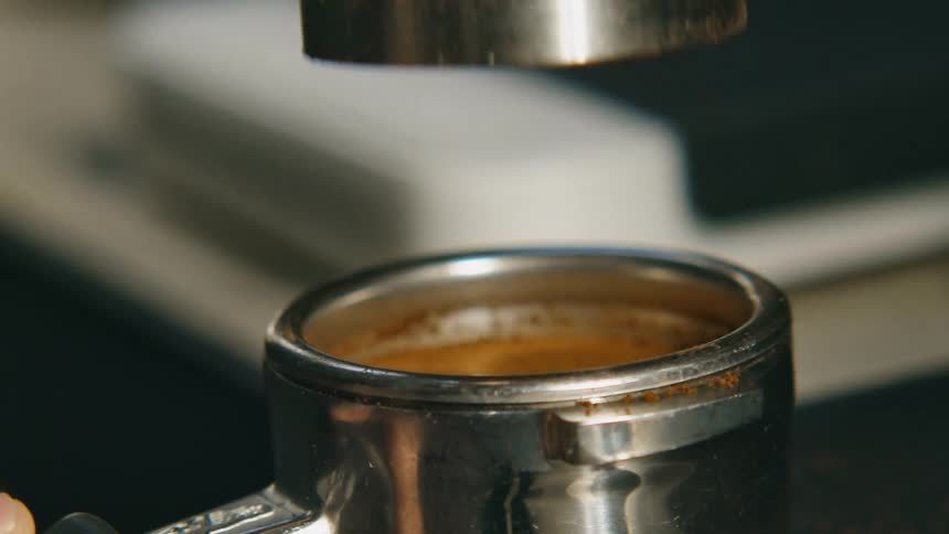 Cover being removed from an espresso container