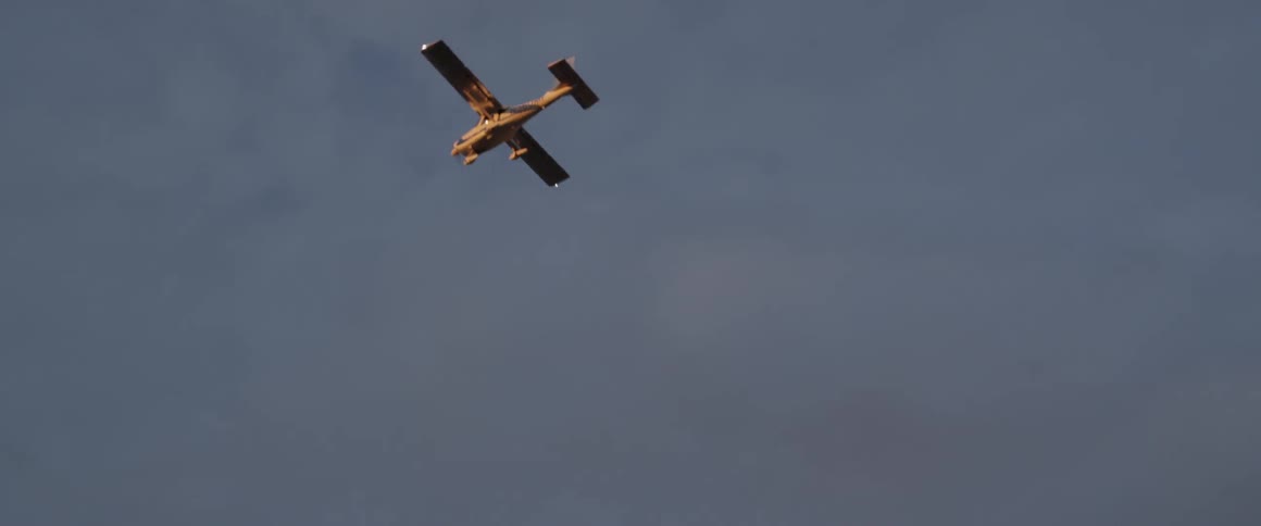 A plane is flying in a cloudy sky