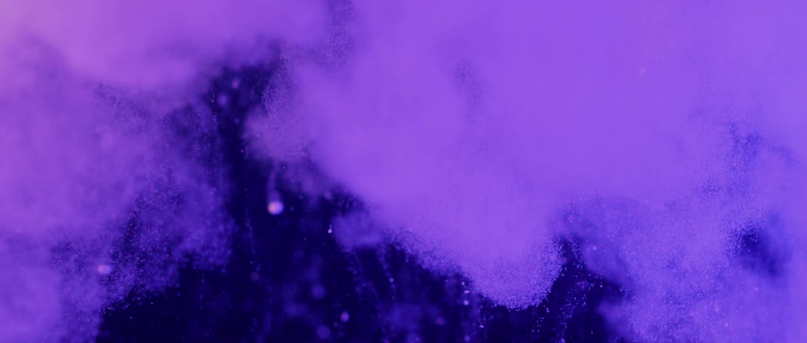 Light colored vapor spreads on a dark background