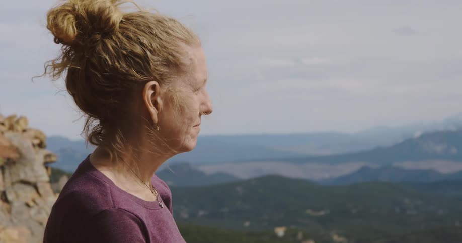 A woman enjoying the view while hiking in mountains