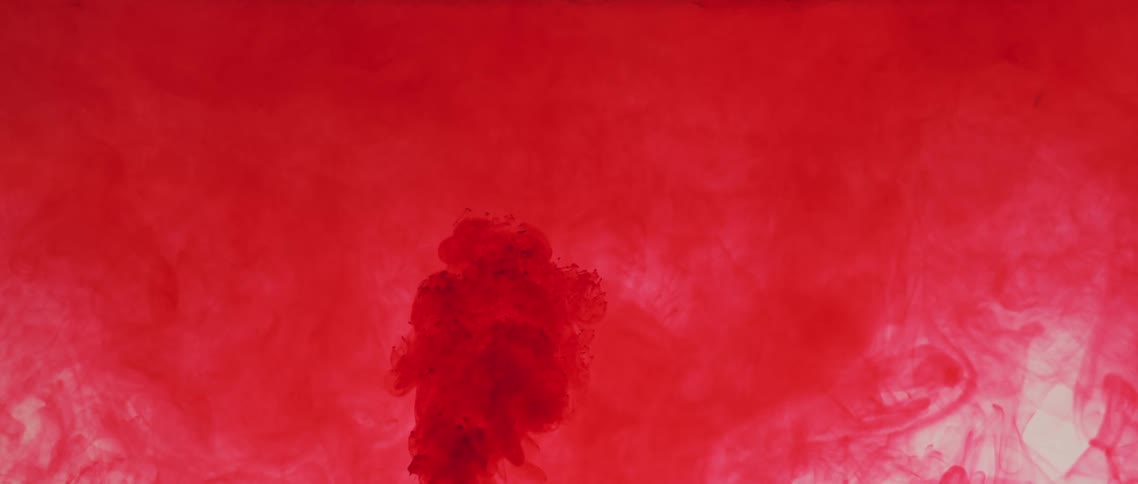 Red smoke floats while a portion of it recedes