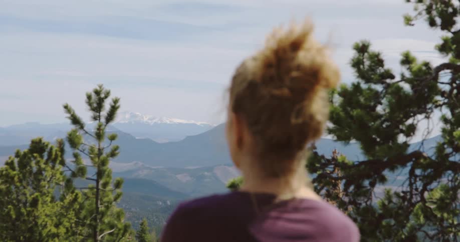 A woman enjoying the view in mountains in the daytime