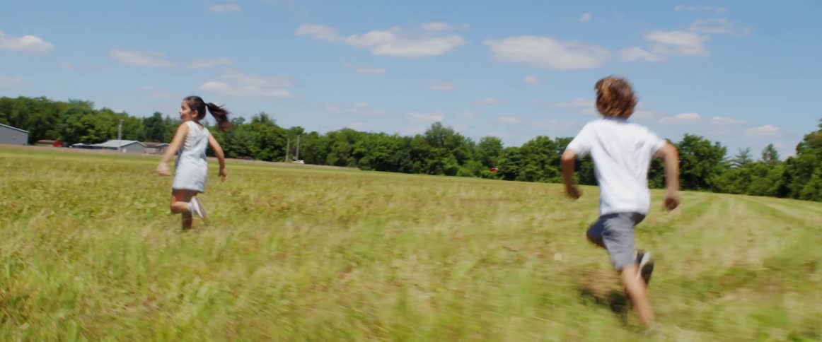 Two children running and playing outdoors