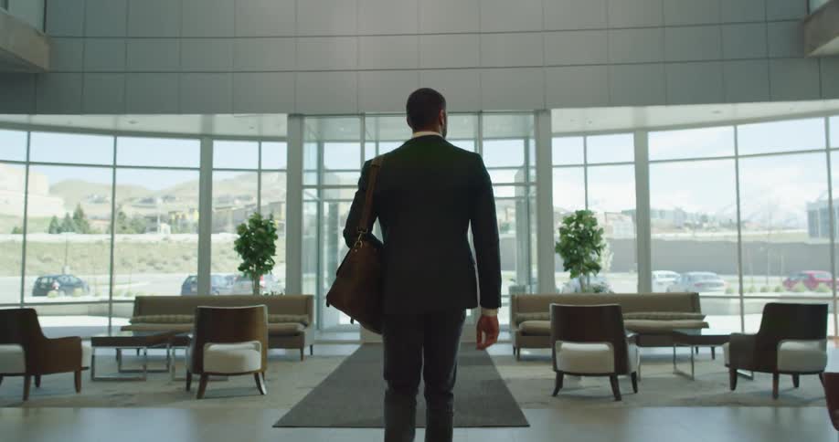 A man walks out of an office building