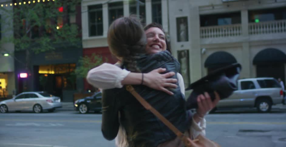 Woman hugging a friend in the city