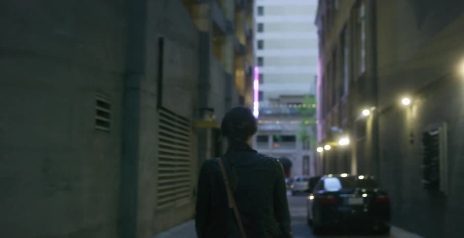 A person walking down an alley