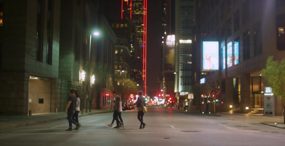 People crossing a street at night