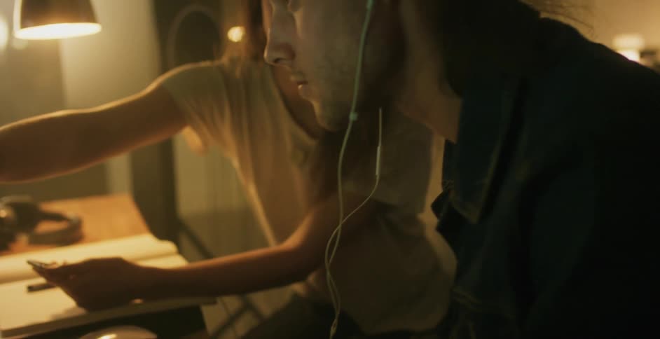A man and woman work at a desk