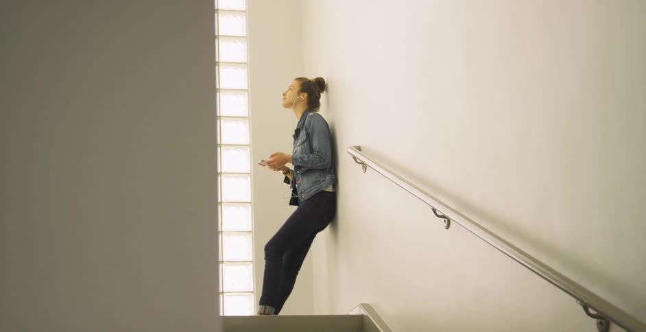 A person standing at the top of a staircase