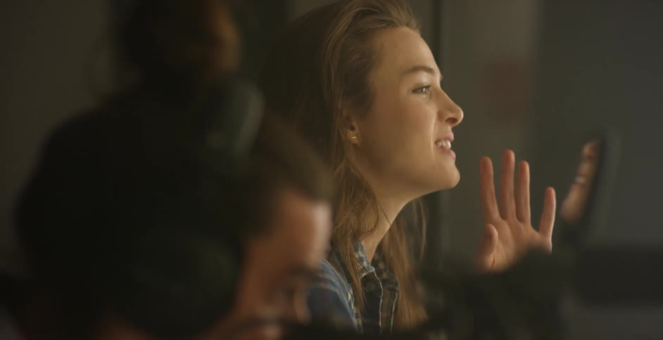 A woman smiles and call out