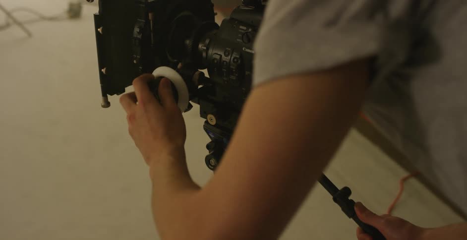 A photographer adjusts equipment