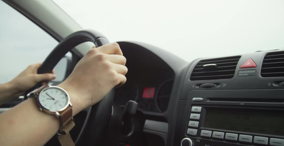 Driver holding car steering wheel