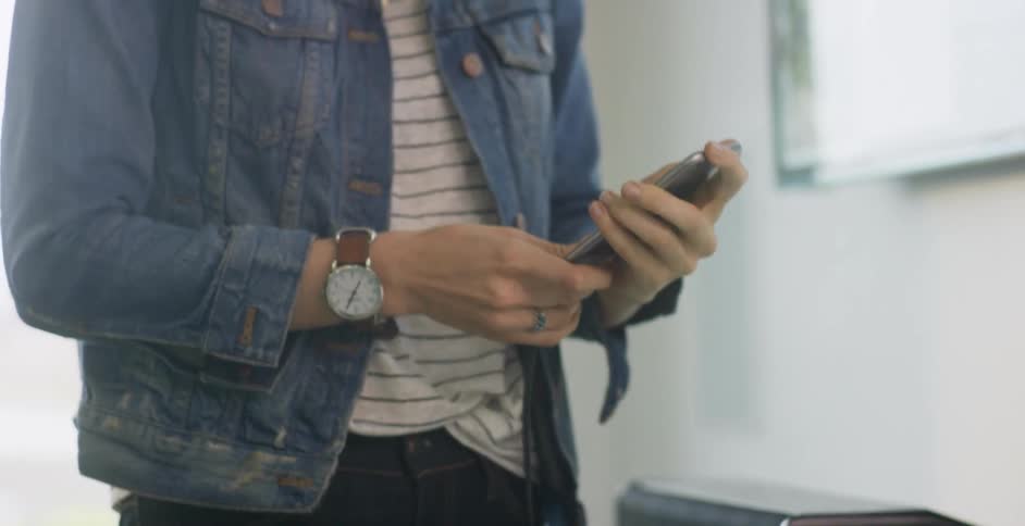A person plugging in their phone to charge